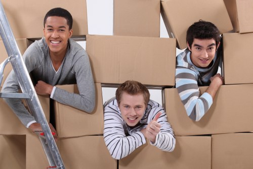 Movers handling desks and IT equipment in an office move