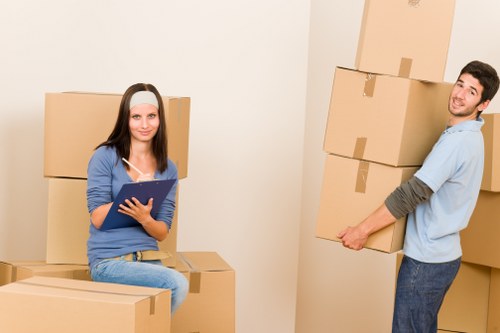 Professional movers unloading boxes into a new Bromley home